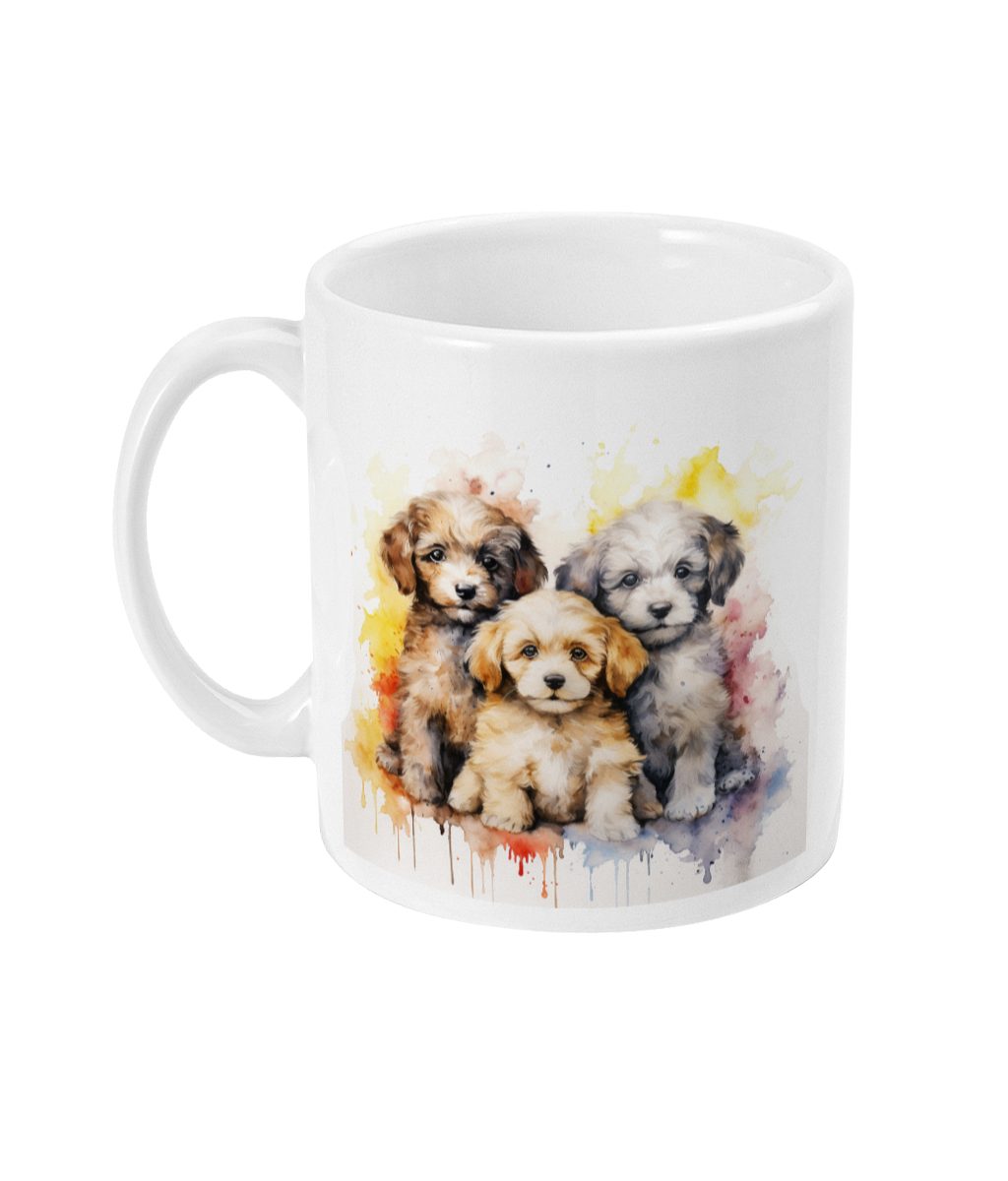 White ceramic mug featuring a watercolor-style graphic of three playful puppies against a colourful backdrop