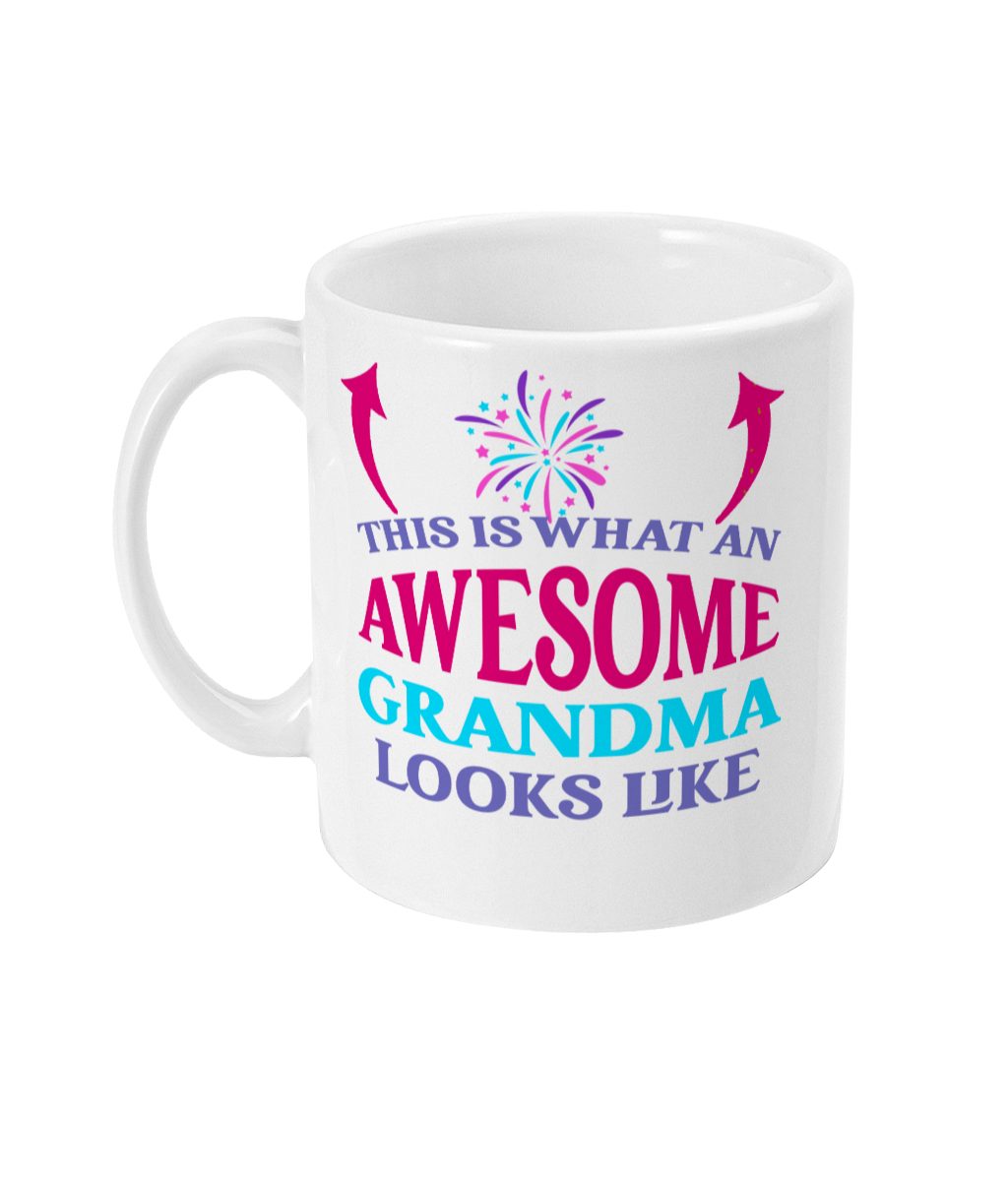 Colorful ceramic mug with text 'THIS IS WHAT AN AWESOME GRANDMA LOOKS LIKE' and festive firework design.