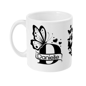 White mug with black butterfly and 'Danielle' emblem surrounded by hearts.