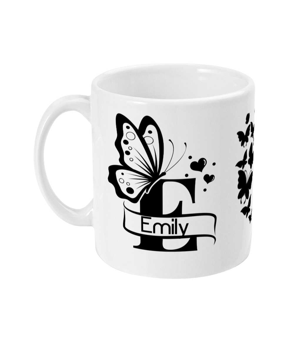 Personalised Letter E Monogram Butterfly Mug featuring intricate black butterflies, hearts, and floral motifs with stylized name 'Emily'.
