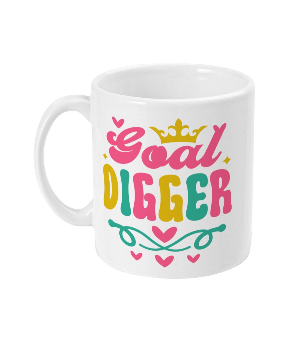 White ceramic mug with 'Goal Digger' in colourful script, adorned with a crown, stars, and hearts in pink, yellow, green, and light blue.