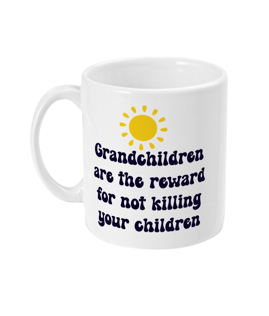 White mug with 'Grandchildren are the reward for not killing your children' text in dark blue font and yellow sun graphic.