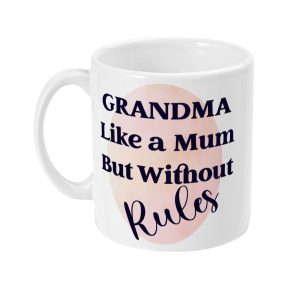White ceramic coffee mug with 'GRANDMA Like a Mum But without Rules' text in bold and cursive fonts, backed by a pink circle design.