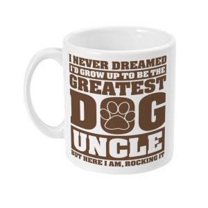 White ceramic mug with brown 'I NEVER DREAMED I'D GROW UP TO BE THE GREATEST DOG UNCLE BUT HERE I AM, ROCKING IT' text design featuring bold 'D' letter and paw print.