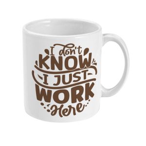 White mug featuring playful brown text 'I don't KNOW I JUST WORK here'