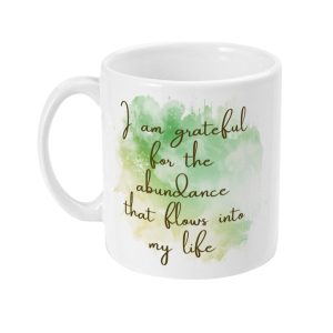 White ceramic mug with green watercolor design and 'I am grateful for the abundance that flows into my life' inscription