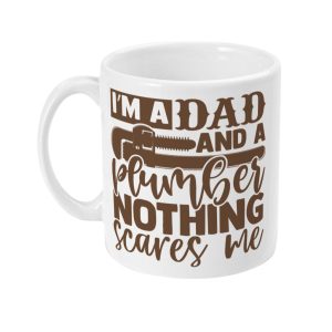 White ceramic mug with bold brown text 'I'm a Dad and a Plumber nothing scares me' and plumbing-themed illustrations.
