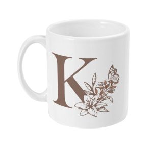 White ceramic mug with large brown letter K, surrounded by floral and butterfly design in shades of brown