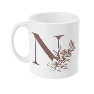 White ceramic mug with elegant brown letter N surrounded by floral and butterfly illustrations, perfect as a personalised gift.