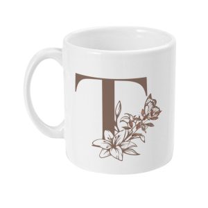 White ceramic mug with brown letter T surrounded by floral and butterfly motifs
