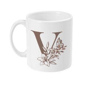 White ceramic mug featuring brown letter 'V' with floral pattern in brown and beige tones
