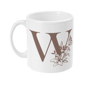 White ceramic mug with a stylized letter W and floral design in brown