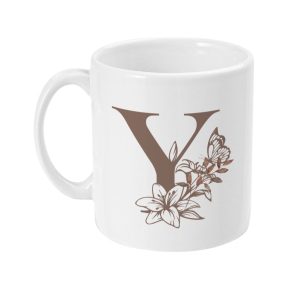 White ceramic mug featuring a large brown letter Y surrounded by floral and butterfly graphics.