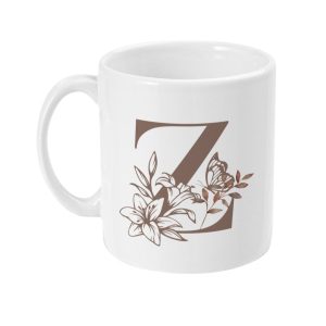 White ceramic mug with a stylized brown letter Z surrounded by floral graphics