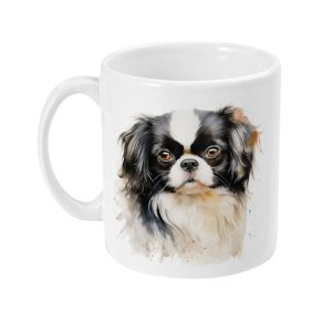 White ceramic mug featuring a detailed graphic of a black, white, and tan long-haired small dog, similar to a Cavalier King Charles Spaniel.