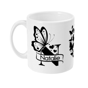 White mug with printed black butterfly design and 'Natalie' banner, surrounded by floral elements.
