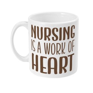 White ceramic mug with 'NURSING IS A WORK OF HEART' phrase in stylized brown font