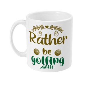 White ceramic mug with green and gold text 'Rather be Golfing', adorned with golf balls and leaf motifs.