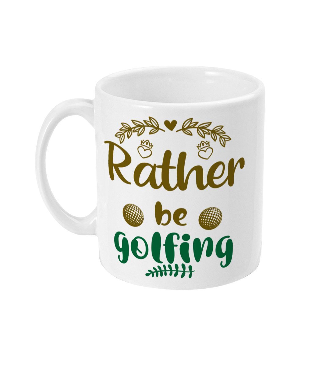 White ceramic mug with green and gold text 'Rather be Golfing', adorned with golf balls and leaf motifs.