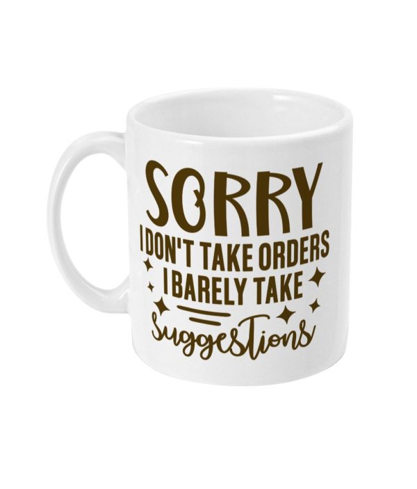 White ceramic mug with bold brown text 'SORRY I DON'T TAKE ORDERS I BARELY TAKE SUGGESTIONS' accented with stars and swirls.