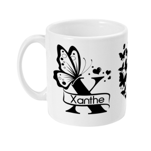 White mug with black butterfly and heart designs, featuring 'Xanthe' on a ribbon banner.