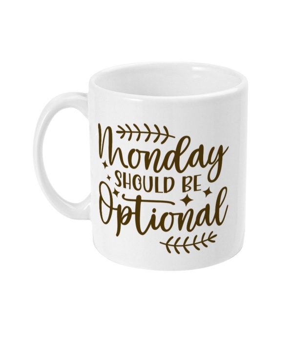 White ceramic mug with gold 'Monday Should Be Optional' text design surrounded by decorative elements